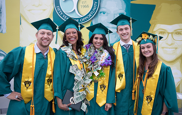 four graduates on stage